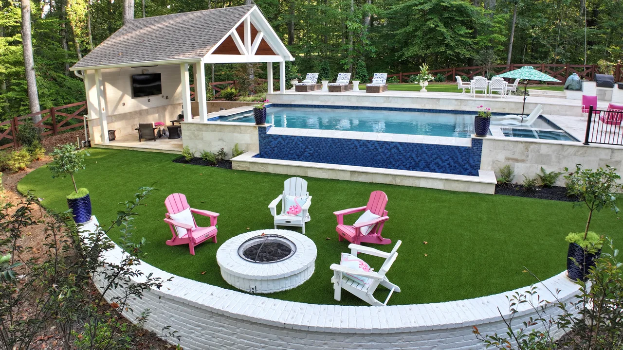 Sunken lawn terrace with custom fire pit and curved retaining wall in Acworth, GA