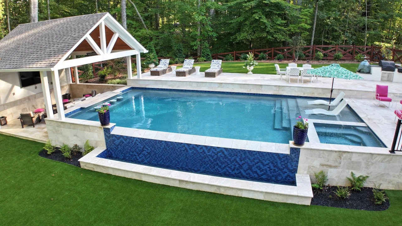 Wide view of custom pool, spa, and travertine surround in Acworth, GA