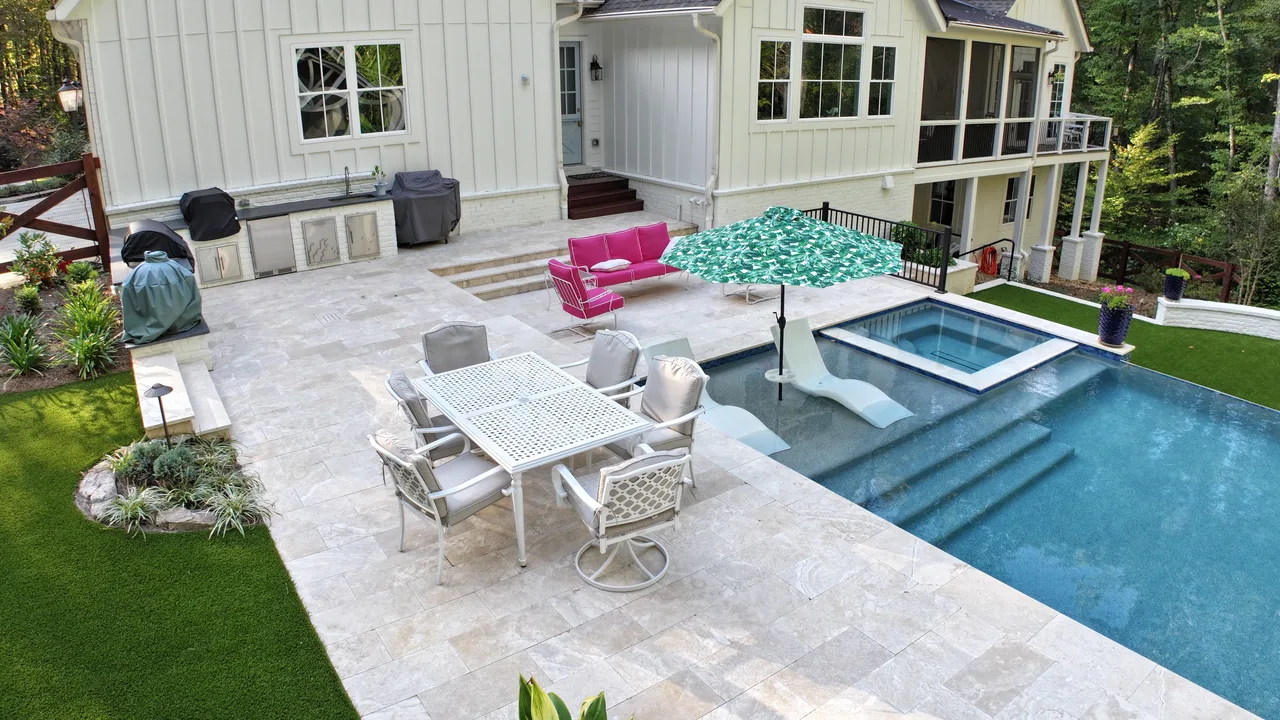 Aerial view of layered outdoor living retreat with pool, patio, and home in Acworth, GA